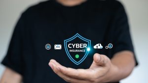Cyber insurance concept with digital shield icon on hand, representing data protection, online security, and cyber risk coverage for business and personal use.
